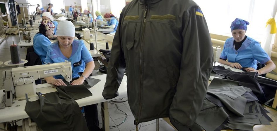 Women sew uniforms for servicemen of Ukrainian forces in the women's  prison in  Mariupol on September 23, 2014. The workshop inside this colony used to produce uniforms for industrial workers and rescuers before switching to military needs after the beginning of the armed conflict in the country's East. AFP PHOTO/ALEXANDER KHUDOTEPLY        (Photo credit should read Alexander KHUDOTEPLY/AFP via Getty Images)